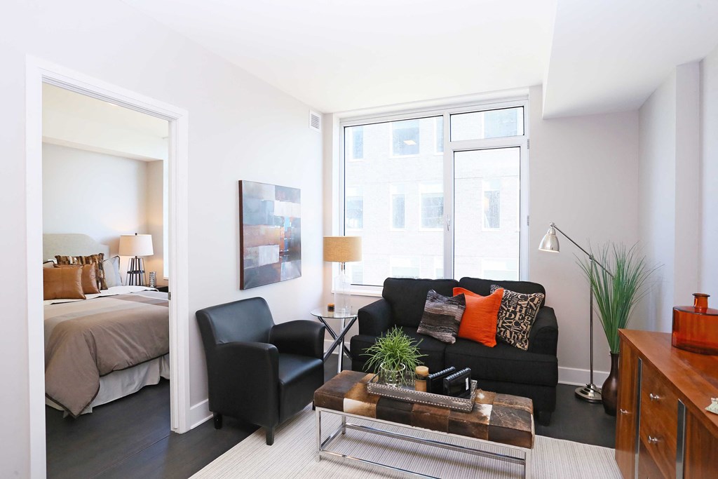 a living room with a couch and a table and a bedroom