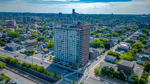an aerial view of a tall building in a city