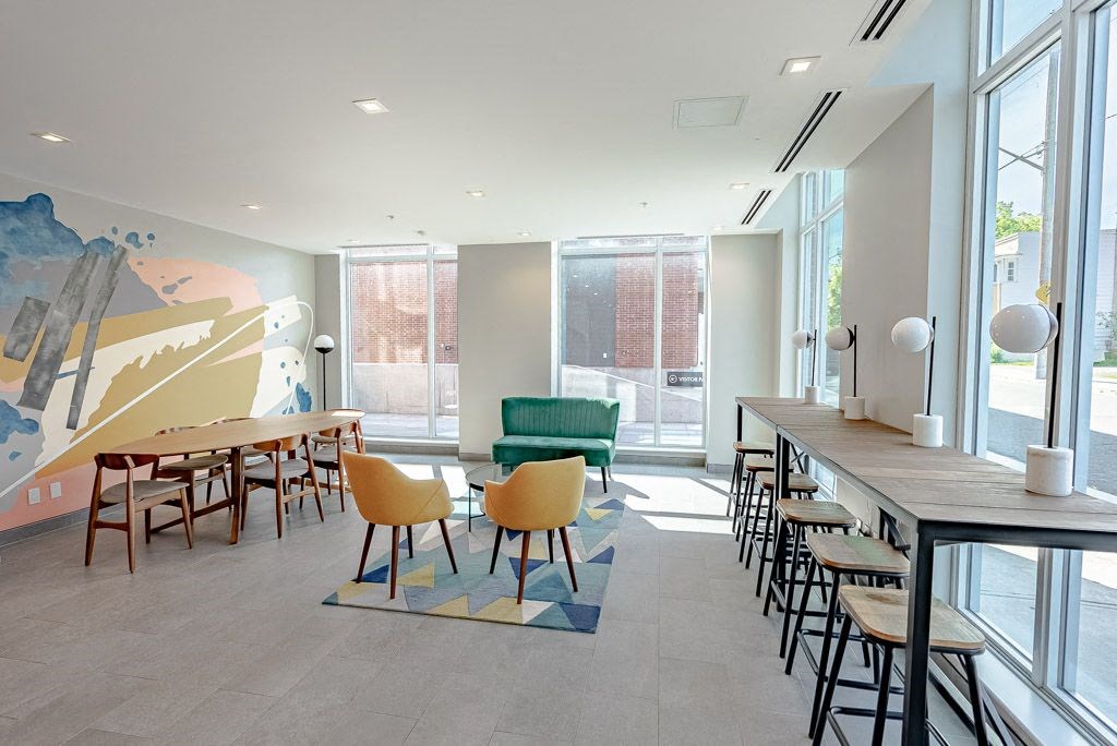a dining room with tables and chairs and a large window
