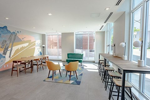 a dining room with tables and chairs and a large window