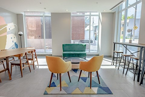 a seating area with a table and chairs in a lobby
