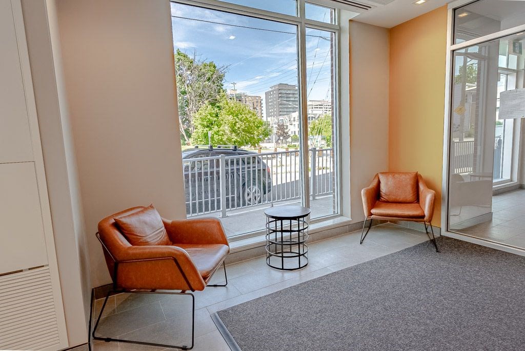 a living room with two chairs and a balcony