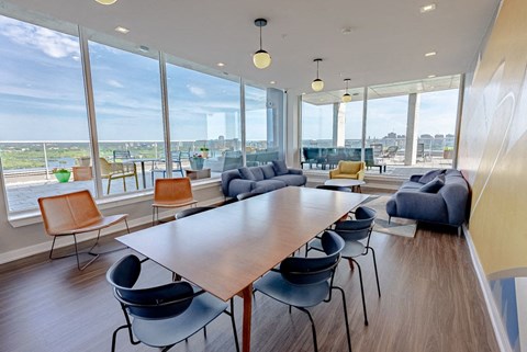 a meeting room with a table and chairs and a view of the city