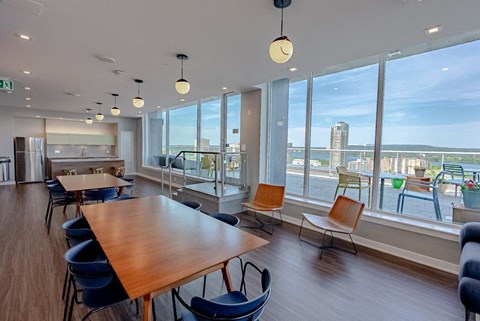 a dining room with a view of a city and a table and chairs