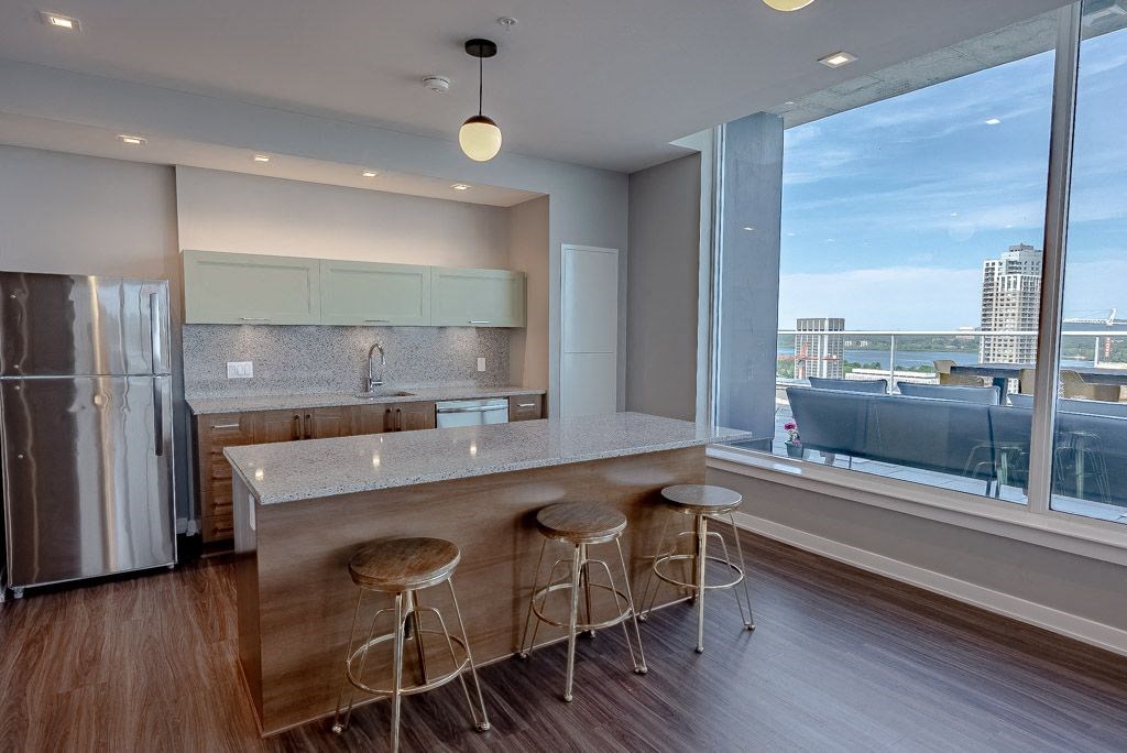 a kitchen with a large window and a counter with three stools