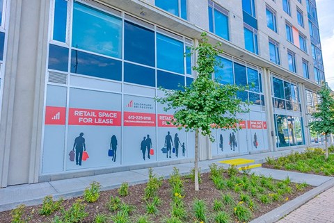 the facade of a building with retail space for lease signage