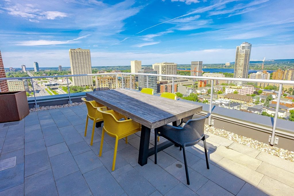 a dining table on a balcony with a view of the city