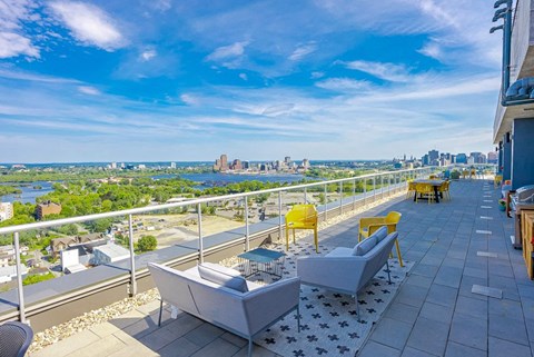 a balcony with a view of the city and a blue sky