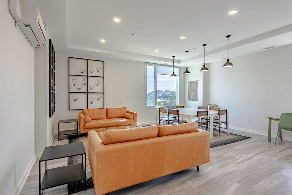 a living room and dining room with couches and a table