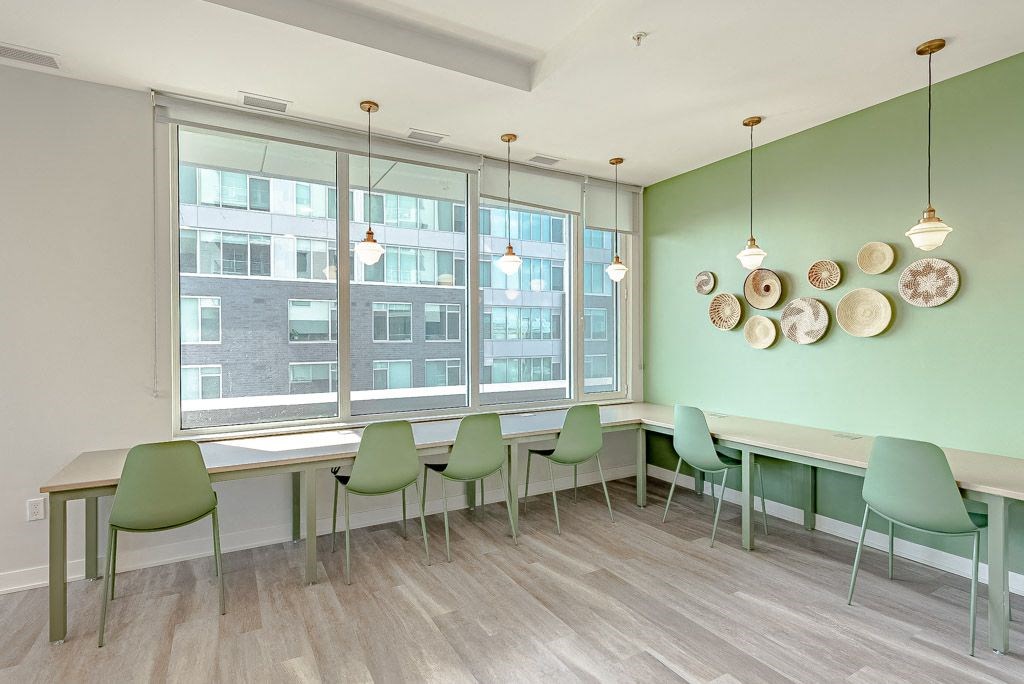 a dining room with a table and chairs and a window