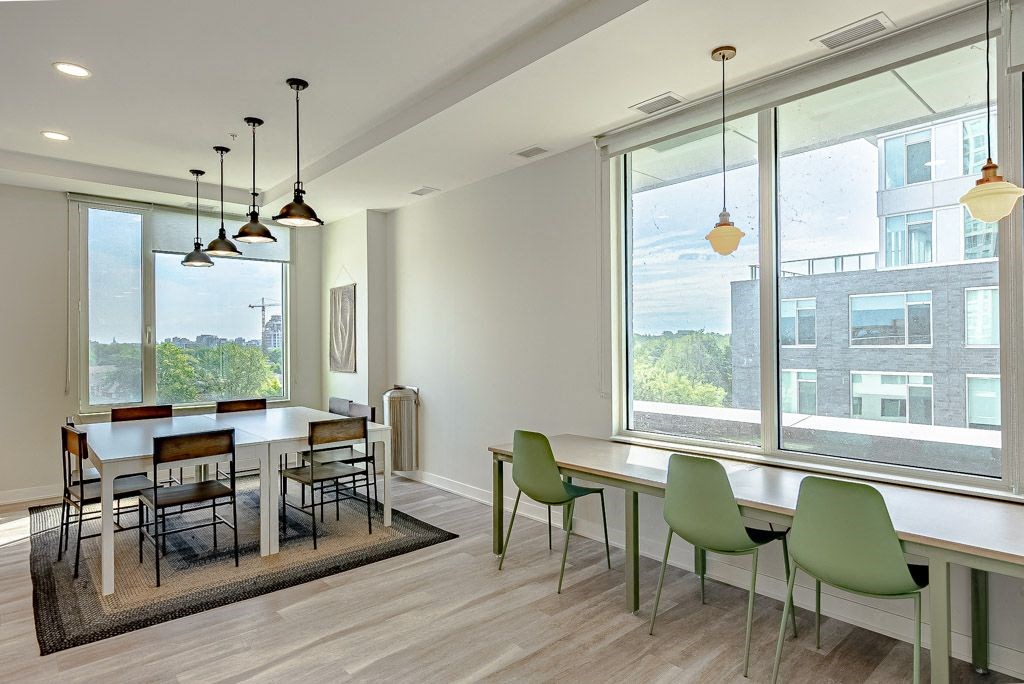a dining room with a large window and a table with chairs