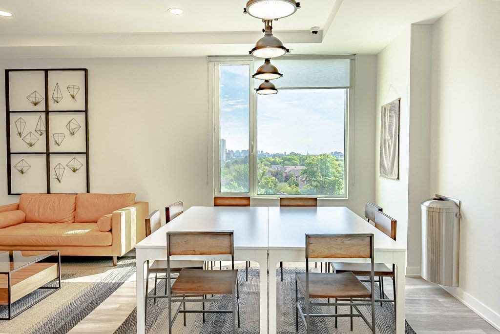 a dining room with a large window and a table and chairs