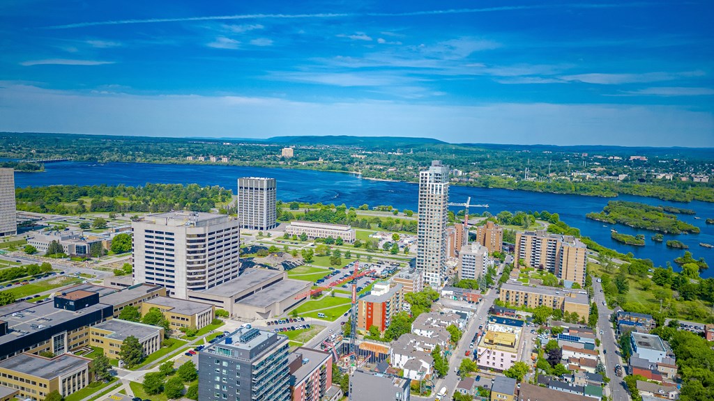 an aerial view of a city with a river and skyscrapers