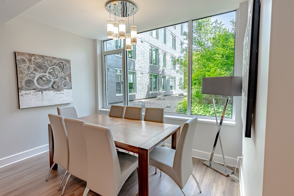 a dining room with a large window and a table with chairs