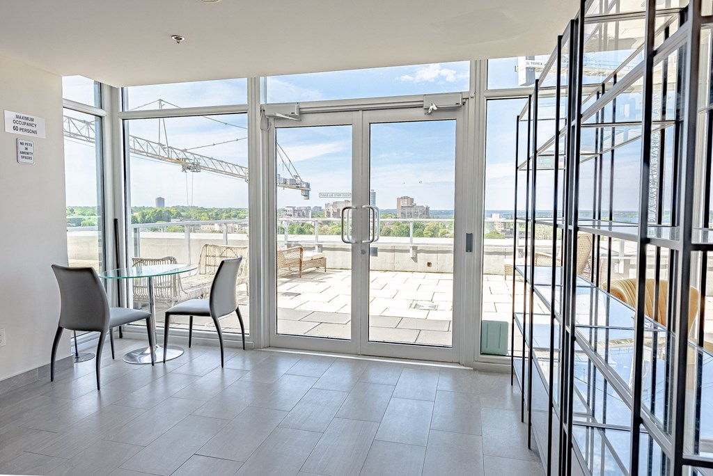 a living room with glass doors and a view of the water