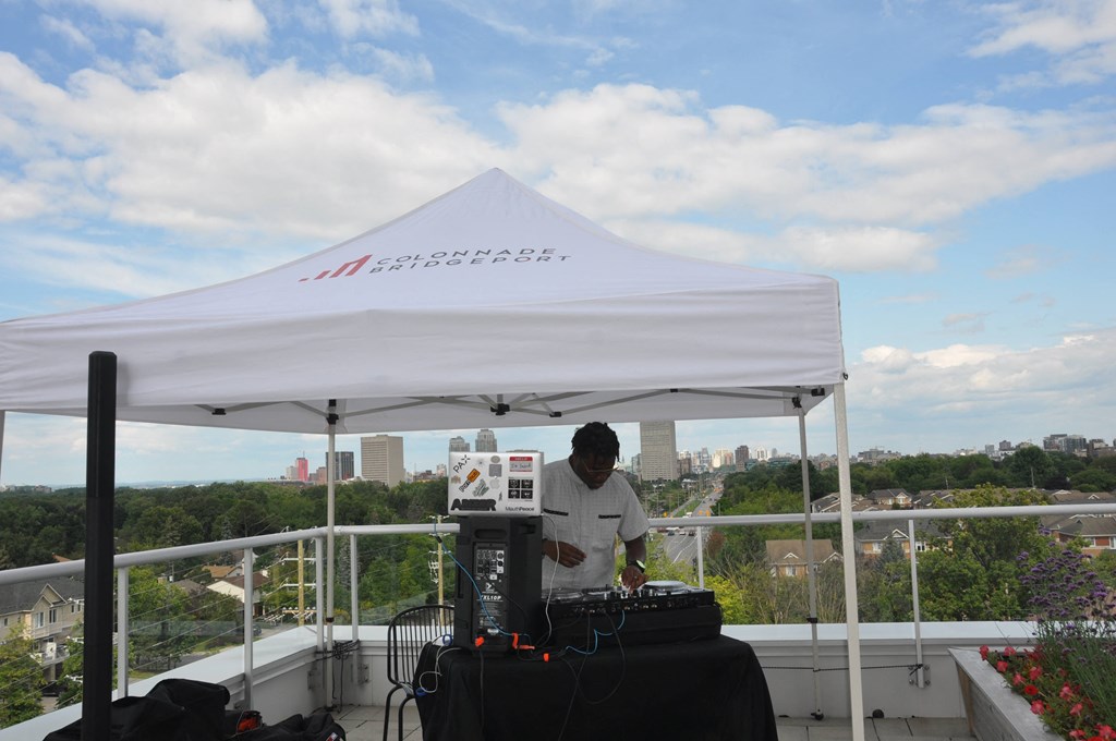 a man standing under a white tent on top of a roof
