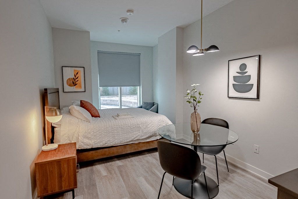 a bedroom with a bed and a glass table