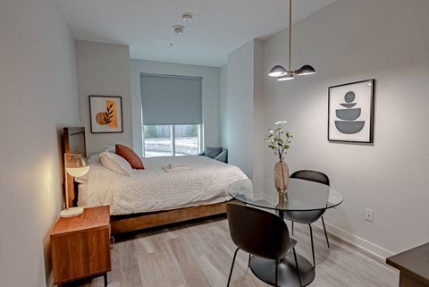 a bedroom with a bed and a glass table