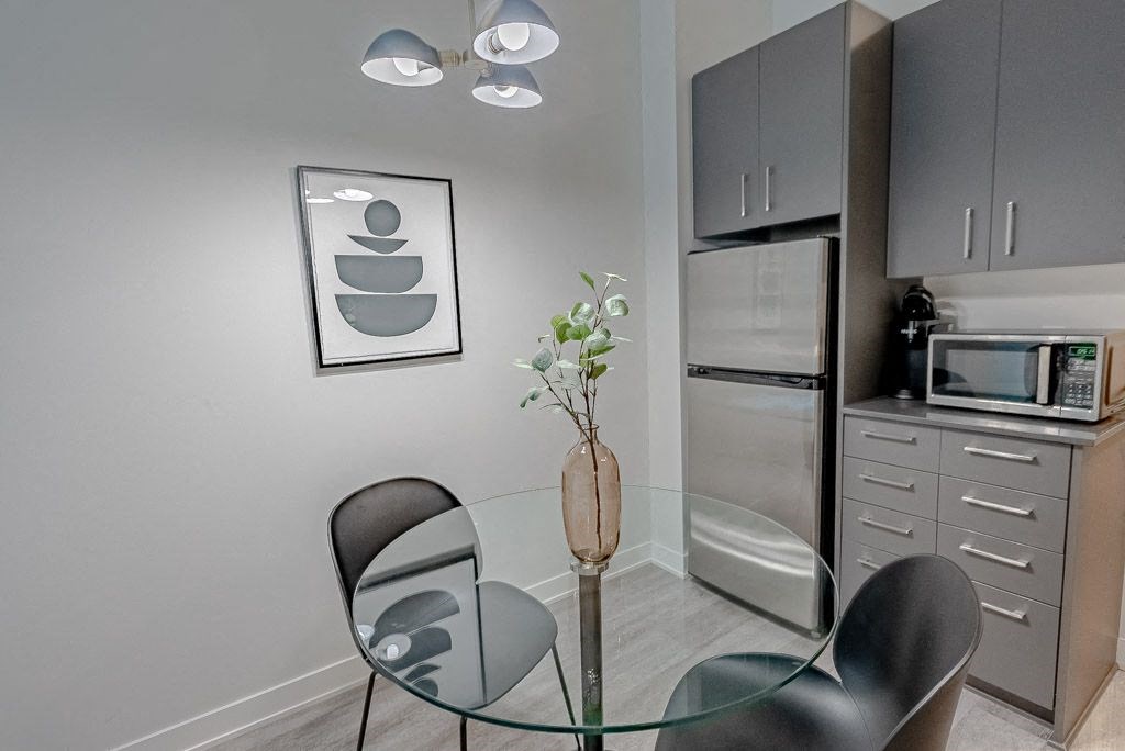 a kitchen and dining room with a glass table and chairs