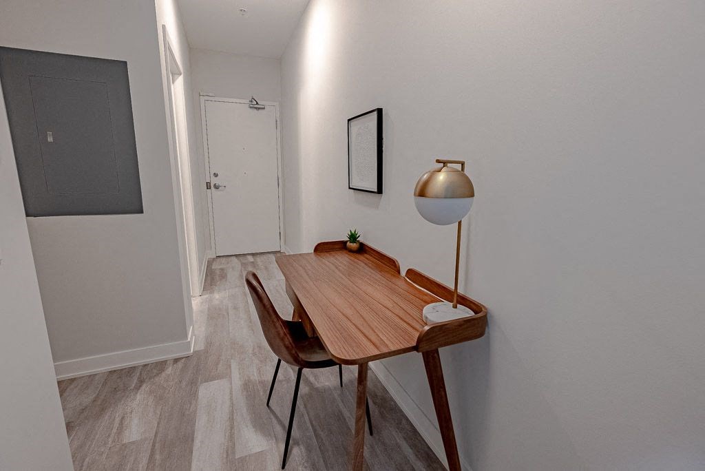 a dining room with a wooden table and a lamp