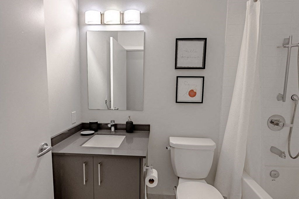 a bathroom with a toilet and a sink and a mirror