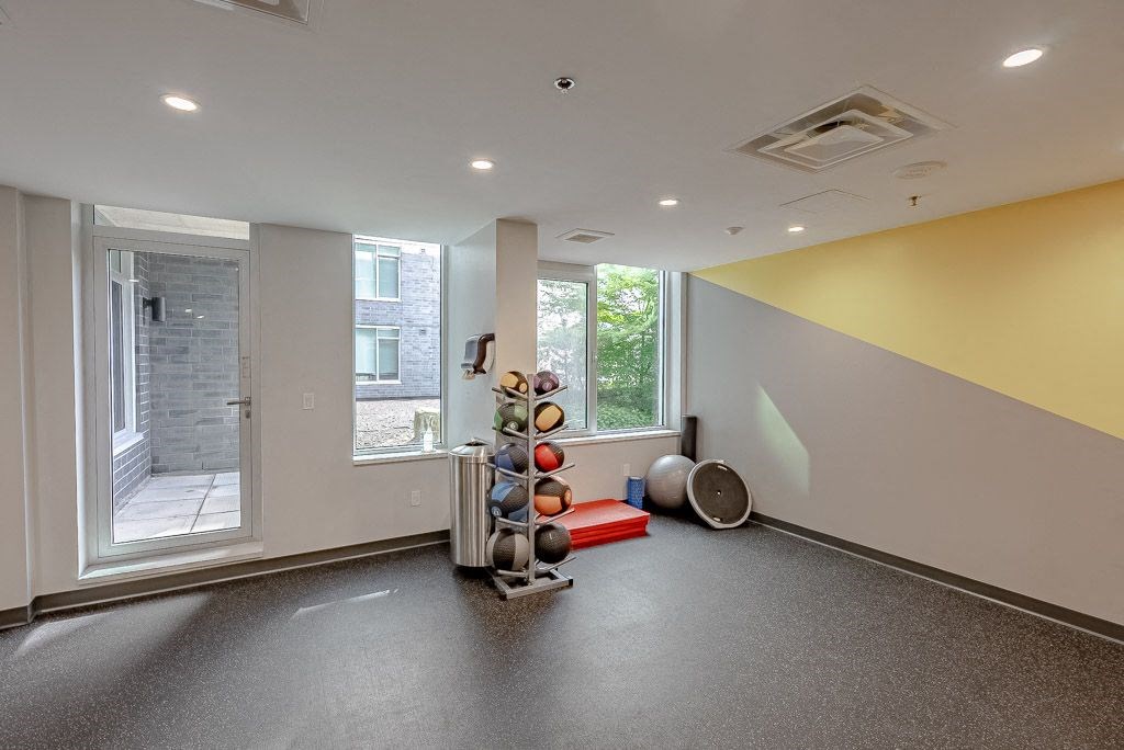 a workout room with weights and other equipment in a building