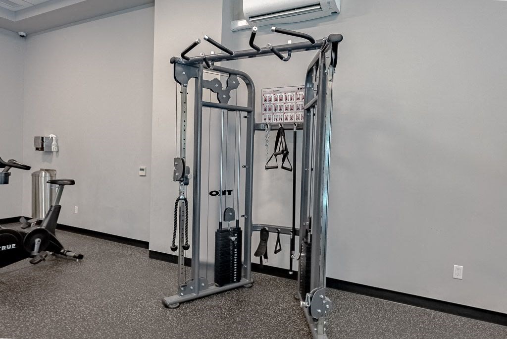 a gym with weights and other equipment in a room