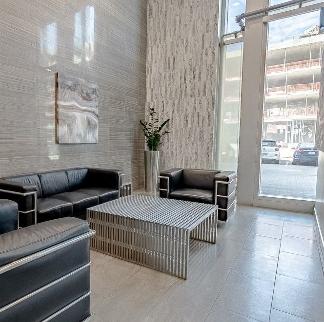 a lobby of a building with couches and a coffee table