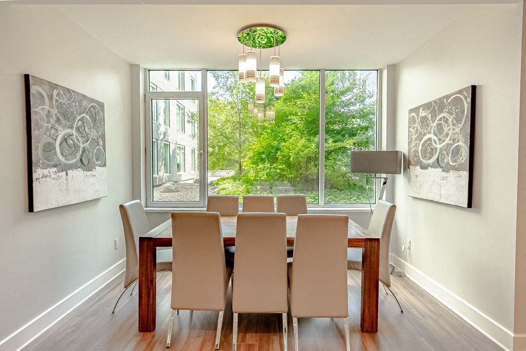a dining room with a table and chairs and a window