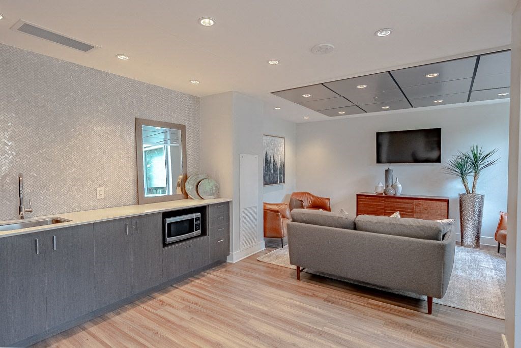 a living room with a couch and a kitchen