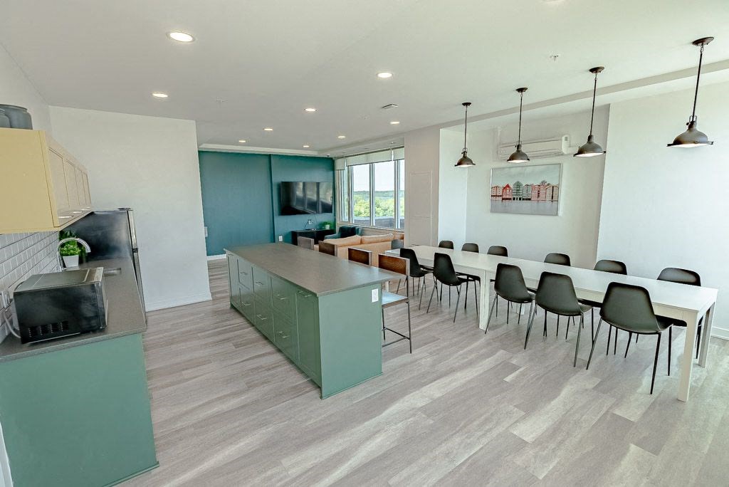a dining room with a table and chairs and a kitchen