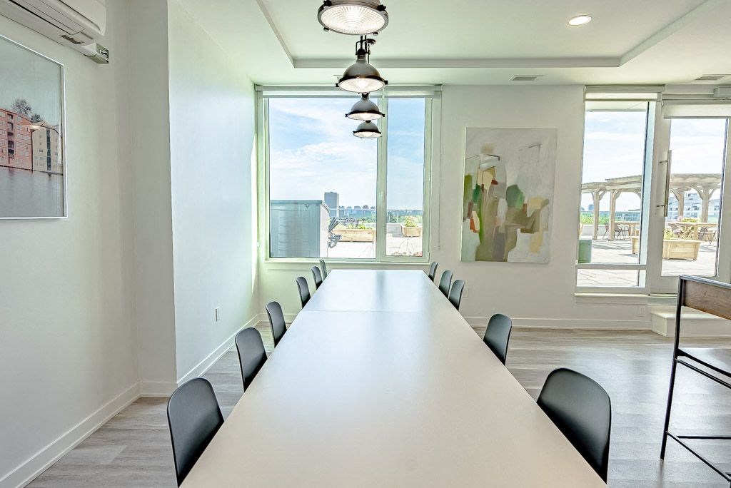 a conference room with a long white table and chairs
