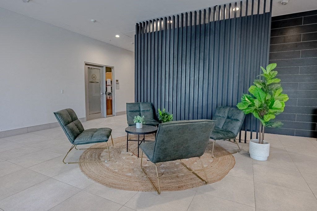 the lobby of a building with chairs and a table