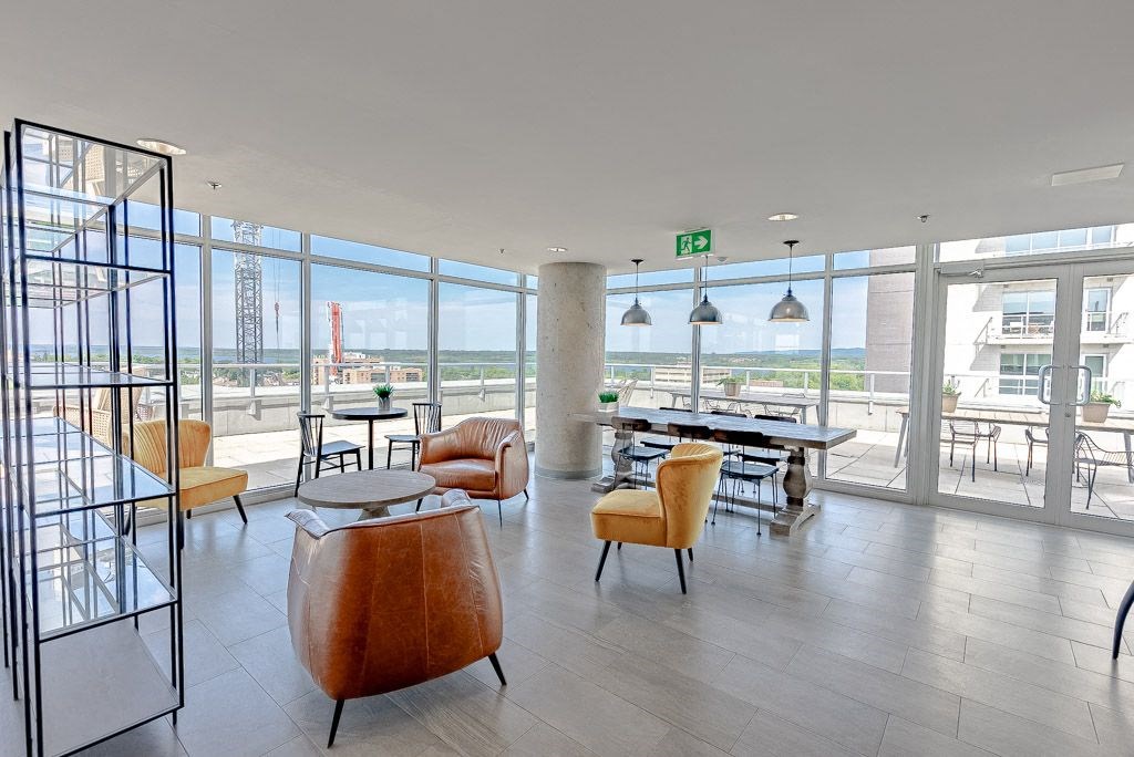 the lobby of a building with chairs and tables