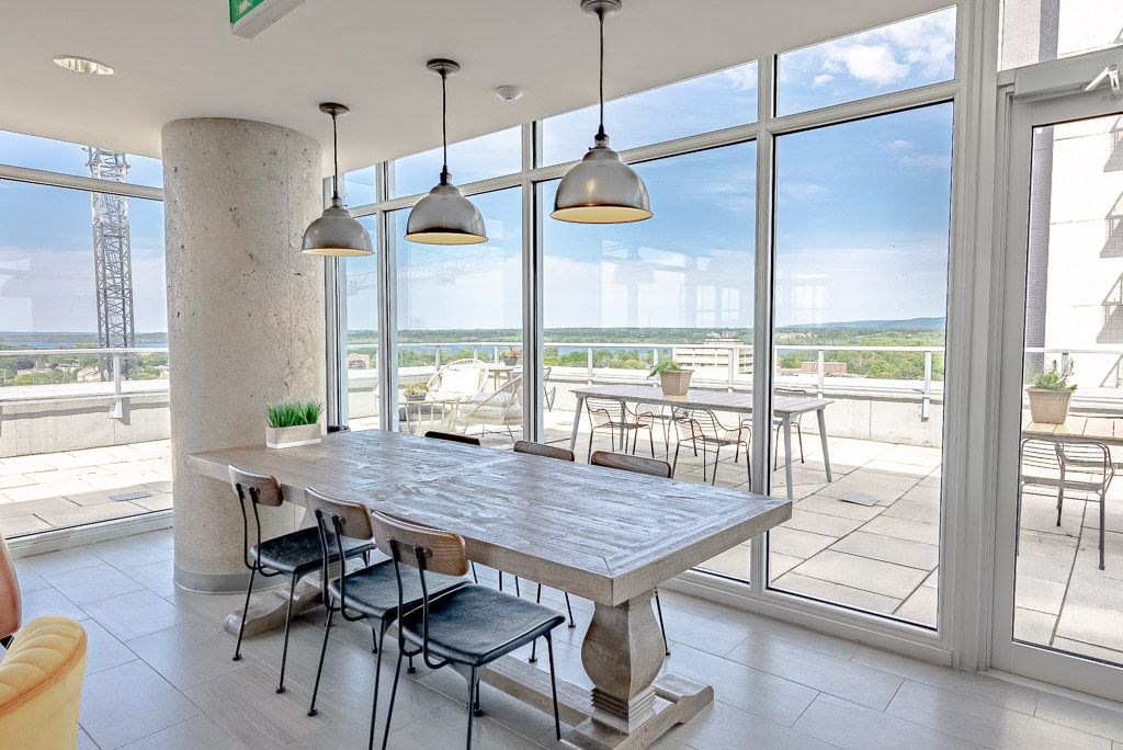 a dining room with large windows and a table with chairs