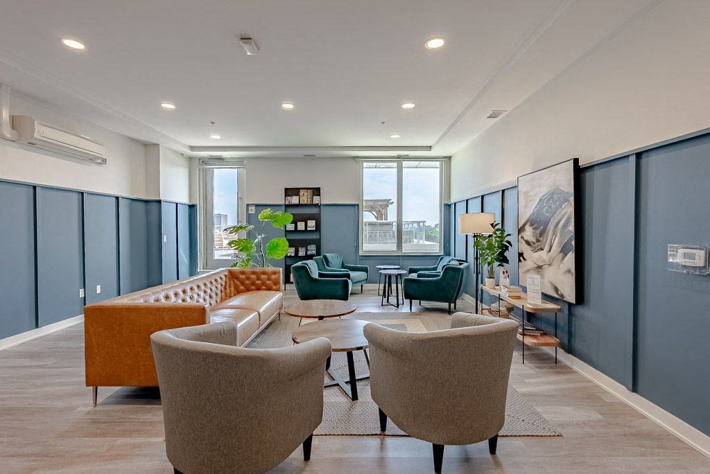 a living room with couches and chairs and a table