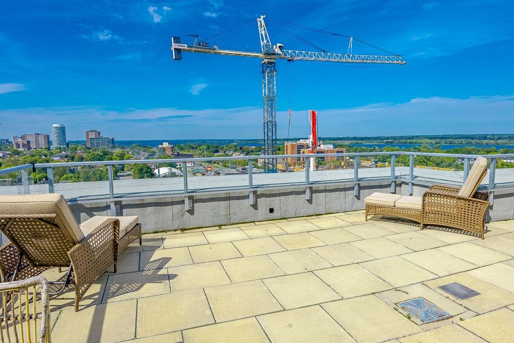 a roof terrace with a view of the city and a crane
