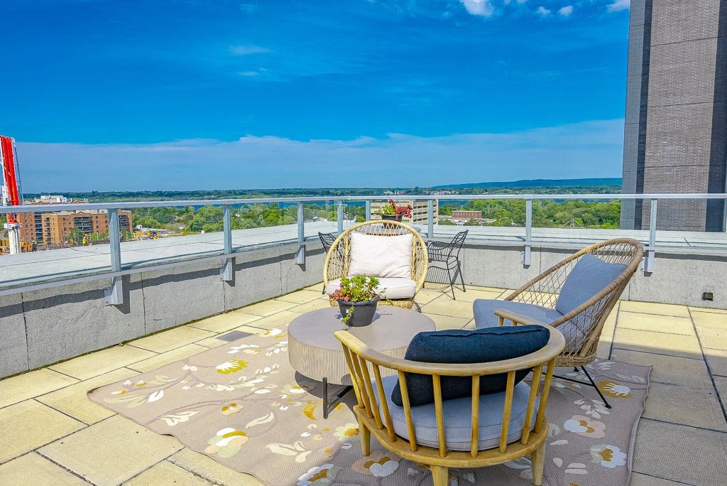 a balcony with two chairs and a table overlooking the ocean
