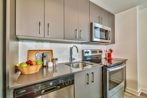 a small kitchen with stainless steel appliances and a sink