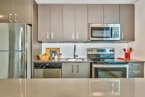 a modern kitchen with stainless steel appliances and stainless steel cabinets