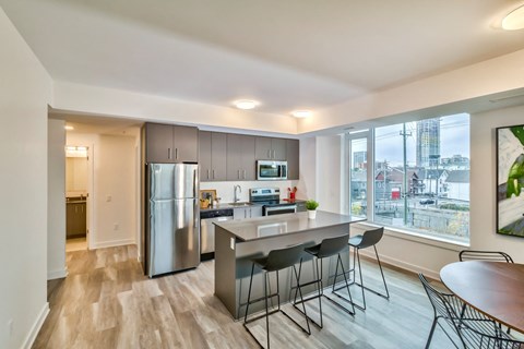 a kitchen with stainless steel appliances and an island with bar stools