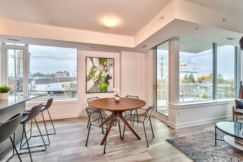 a dining room with a table and chairs and a large window