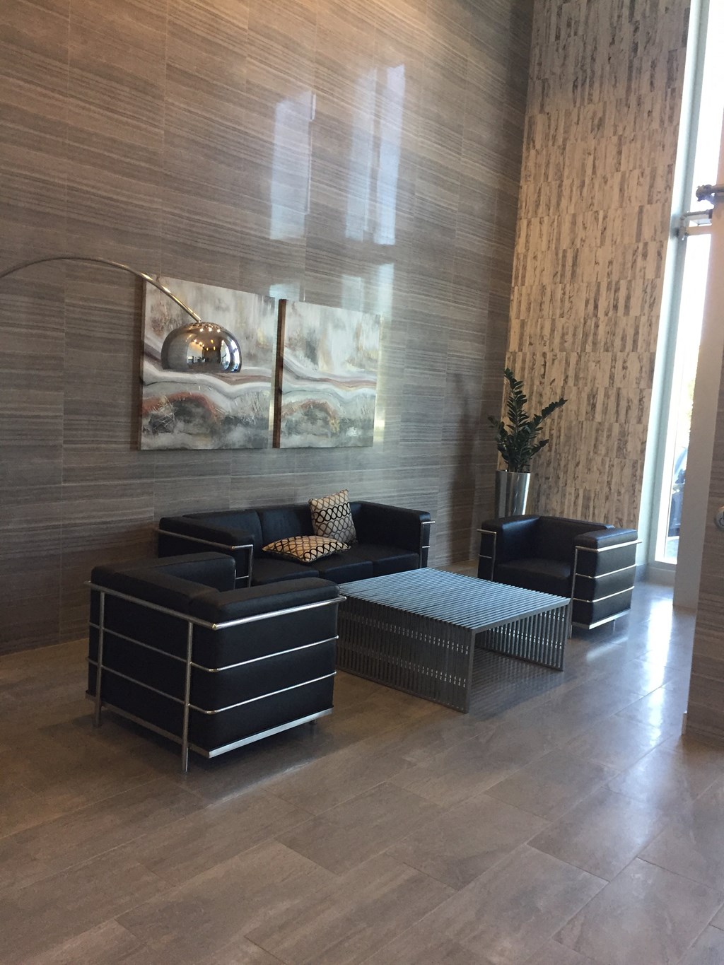 a living room with couches and a table and a lamp