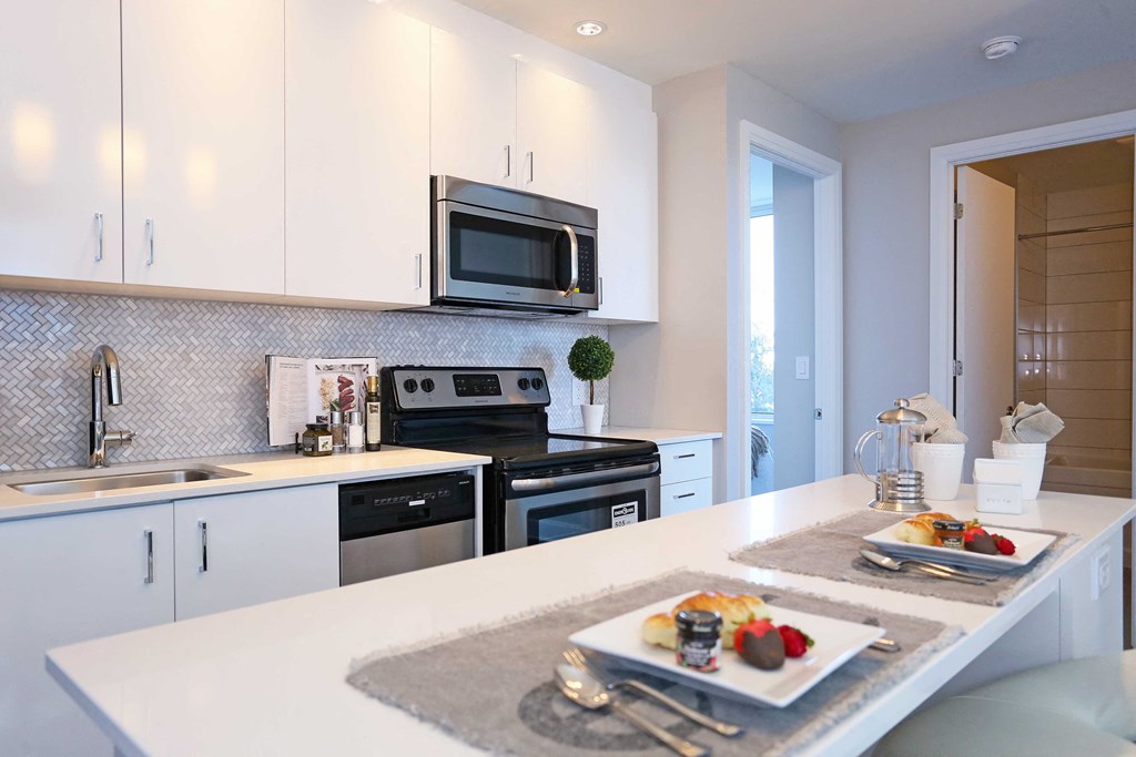 a white kitchen with a plate of food on the counter