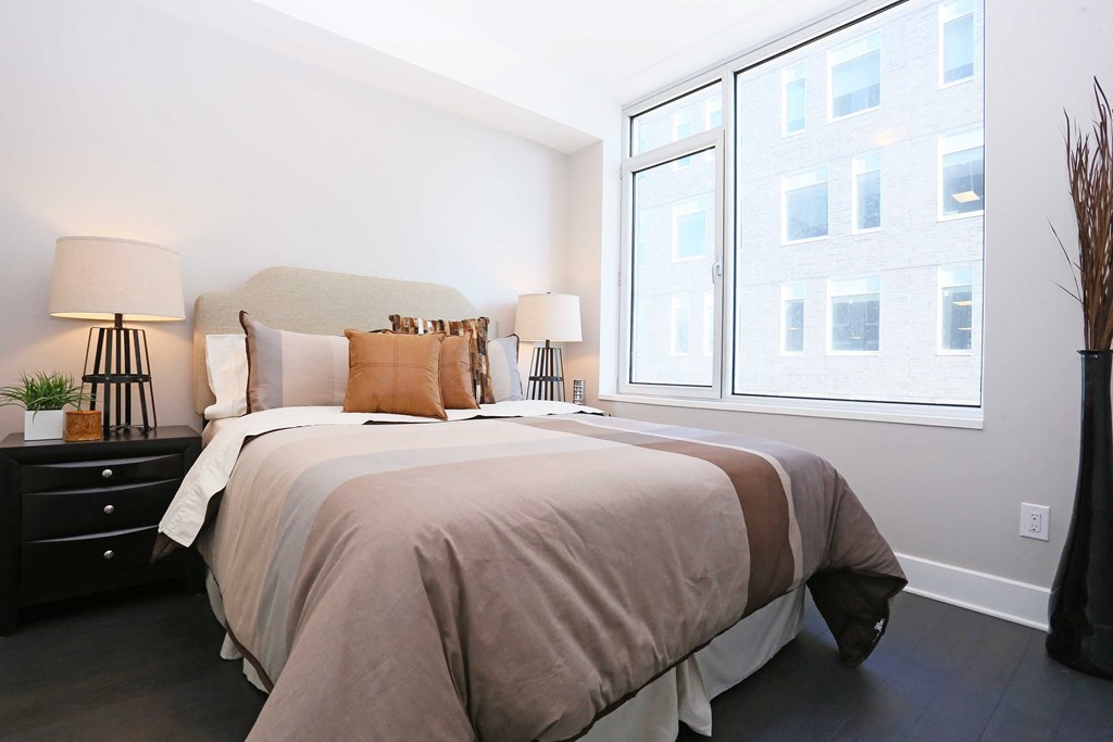 a bedroom with a large bed and a window