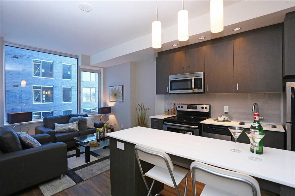 a kitchen and living room with a table and chairs