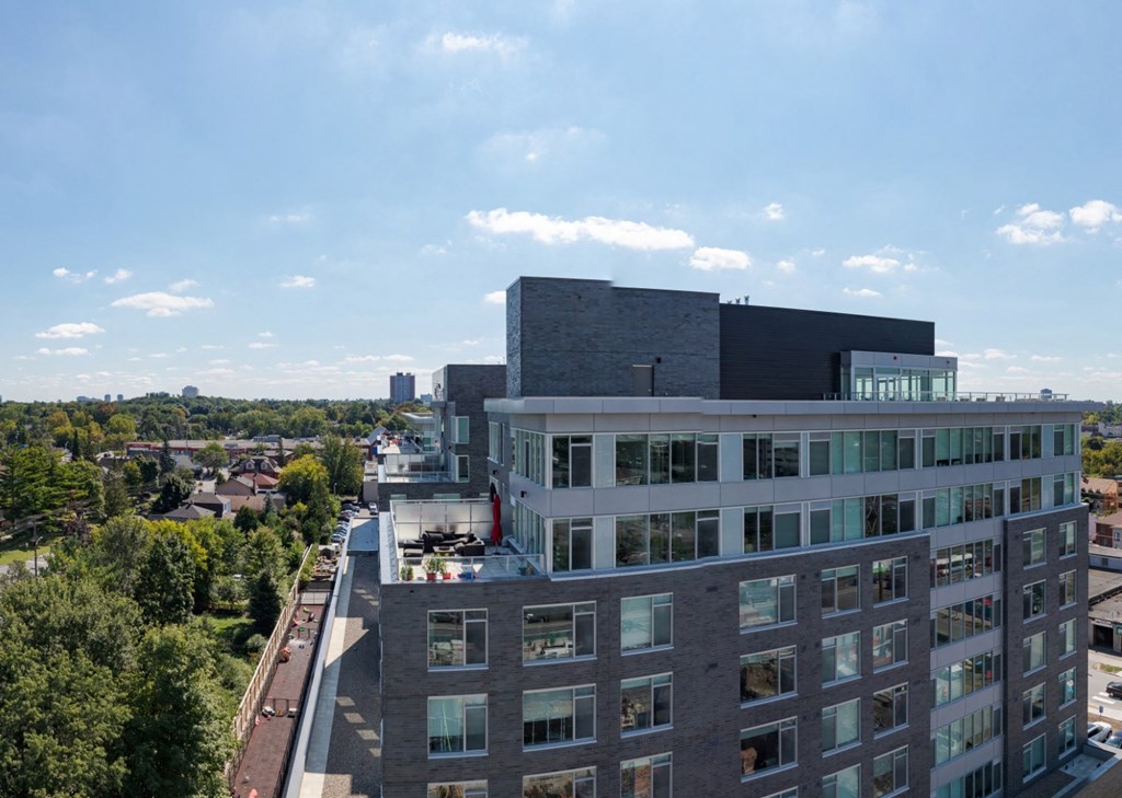 an aerial view of a building with a city in the background