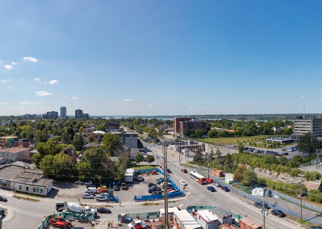 an aerial view of a busy city street with cars and trees