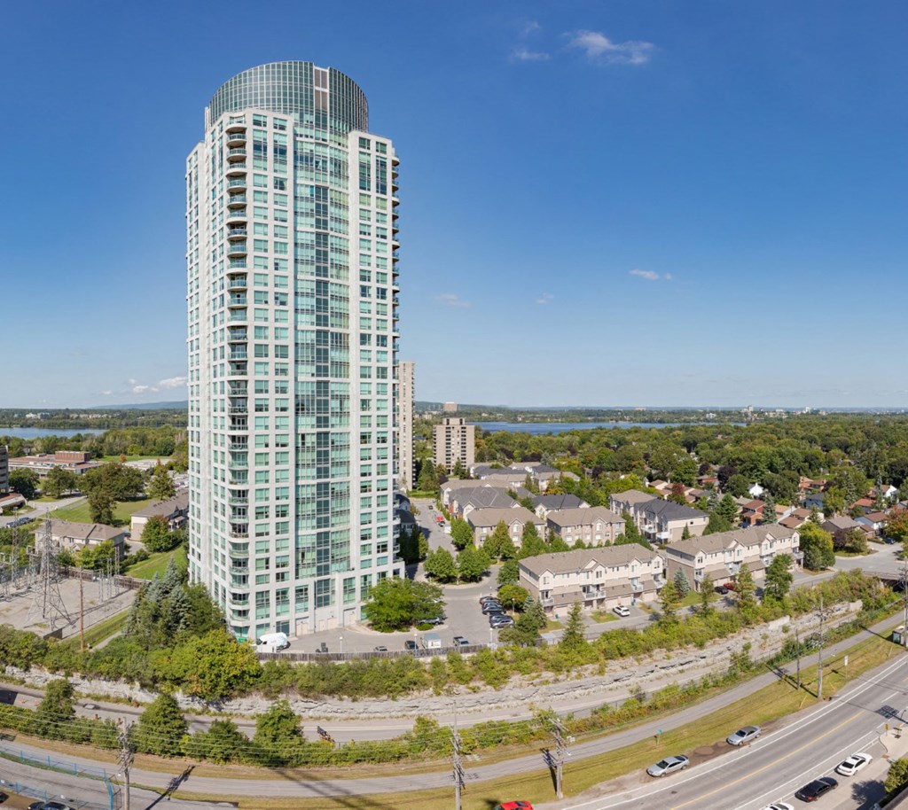 an aerial view of a tall skyscraper in a city