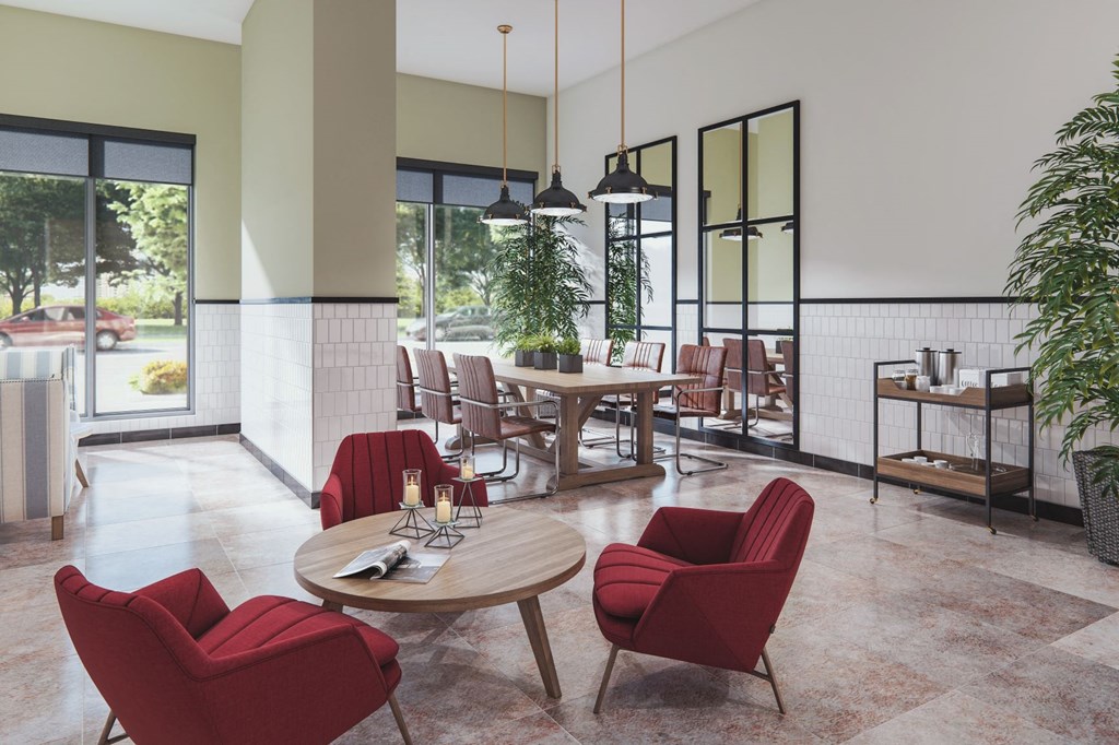 a lobby with chairs and tables and windows